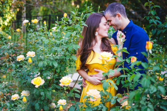 In this captivating photograph captured by Castaldo Studio, a couple stands embraced in a beautiful garden. Surrounded by blooming flowers and lush greenery, their love blooms like the vibrant petals around them. The gentle touch and genuine affection between them is evident as they share a heartfelt embrace. The serene ambiance of the garden adds to the romantic atmosphere, making this moment truly enchanting. Castaldo Studio expertly captures the tenderness and intimacy of this couple's connection, immortalizing their love in this stunning image.