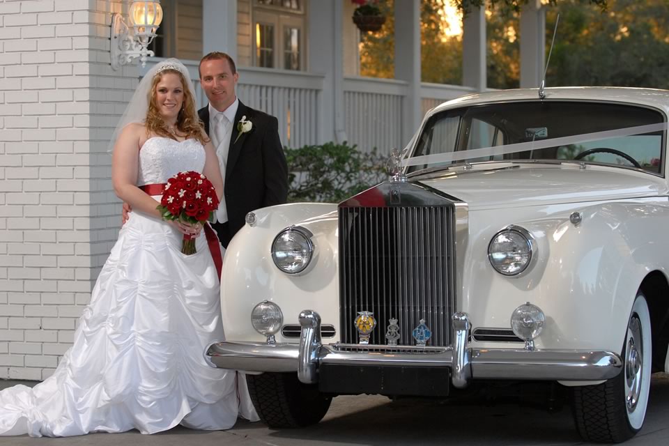 Smiling Bride and Groom with Bouquet in 1957 Rolls-Royce Silver Cloud Diana by VIP Wedding Transportation