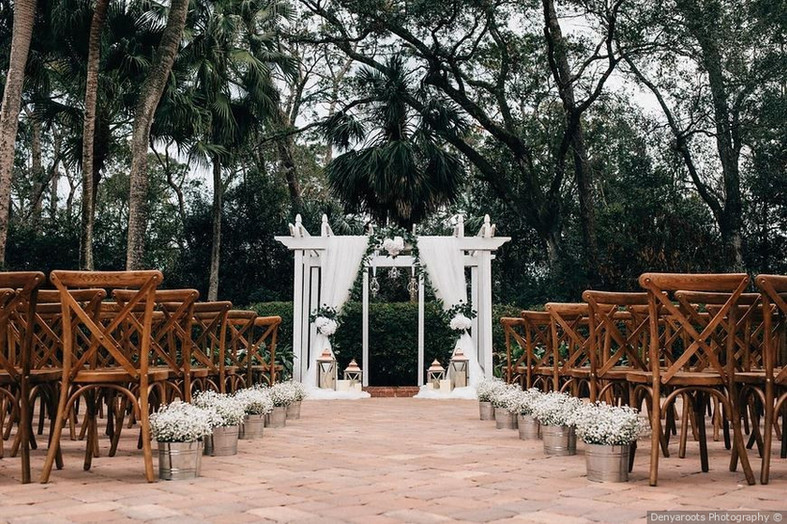 The Garden Villa: Enchanting Outdoor Wedding Setting with Beautiful Flowers and Elegant Altar