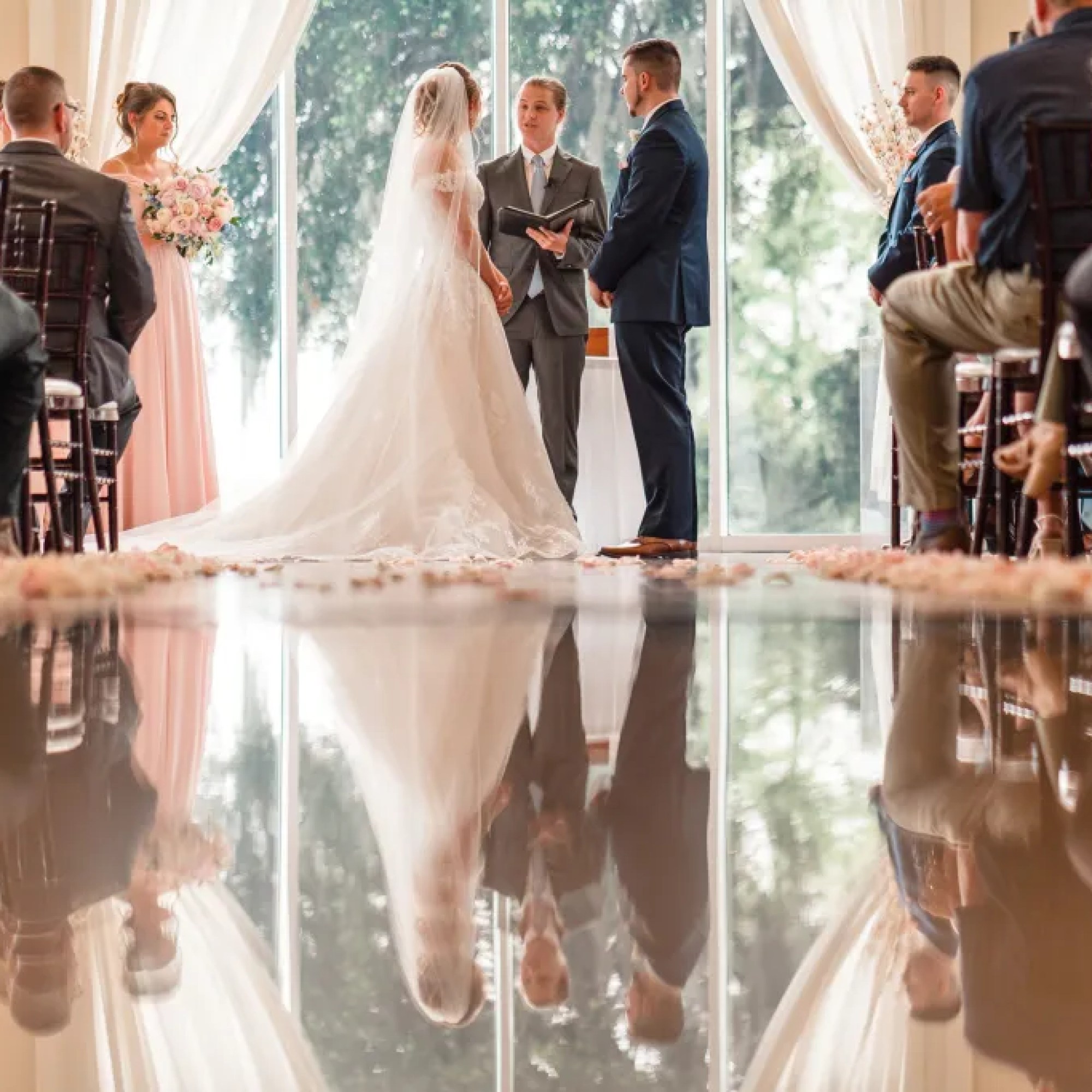 Captivating low-angle shot taken by Jerzy Nieves Photography, showcasing the heartfelt moment of the couple during their wedding ceremony. The unique perspective adds depth and intimacy to the scene