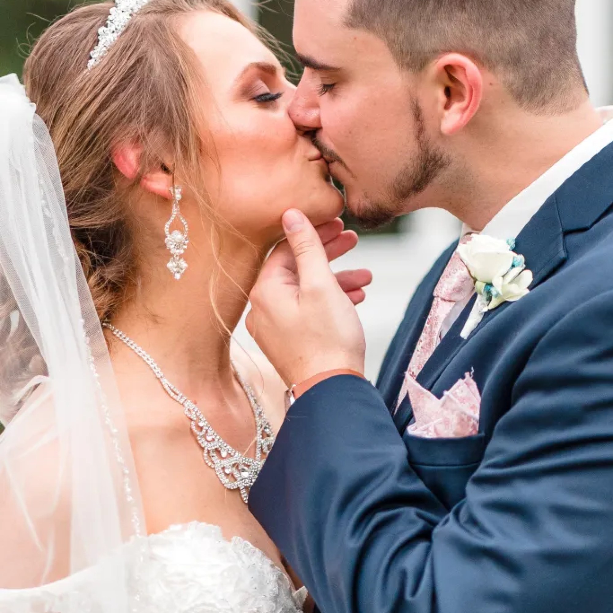 Jerzy Nieves Photography - Romantic moment captured as the bride and groom share a tender kiss, expressing their love and happiness at All Inclusive Weddings Orlando