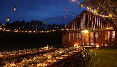 Stunningly set table at night, adorned with candles and expertly arranged by Cocktails Catering for a wedding event.