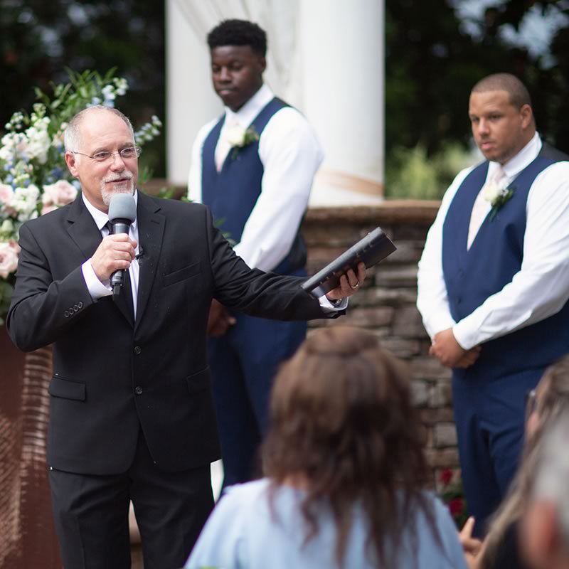 Ceremonies By Ray at All Inclusive Weddings Orlando, capturing the essence of the wedding ceremony. Ray, the officiant, delivers a heartfelt and inspiring speech, setting the tone for a memorable and meaningful celebration