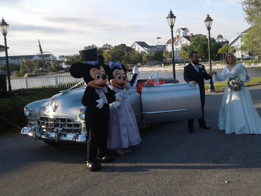 Mini and Mickey Mouse with Bride and Groom in front of Classic Cadillac Convertible VIP Transport