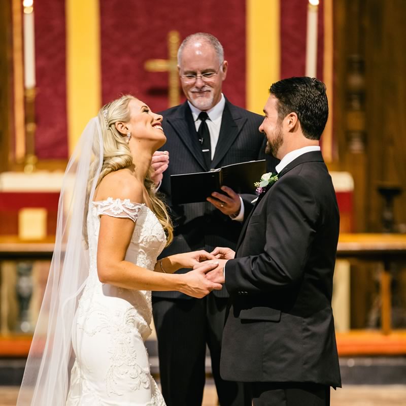 Ceremonies By Ray at All Inclusive Weddings Orlando, capturing the beautiful bond between the bride and groom as they share smiles and laughter during their wedding ceremony, creating cherished memories