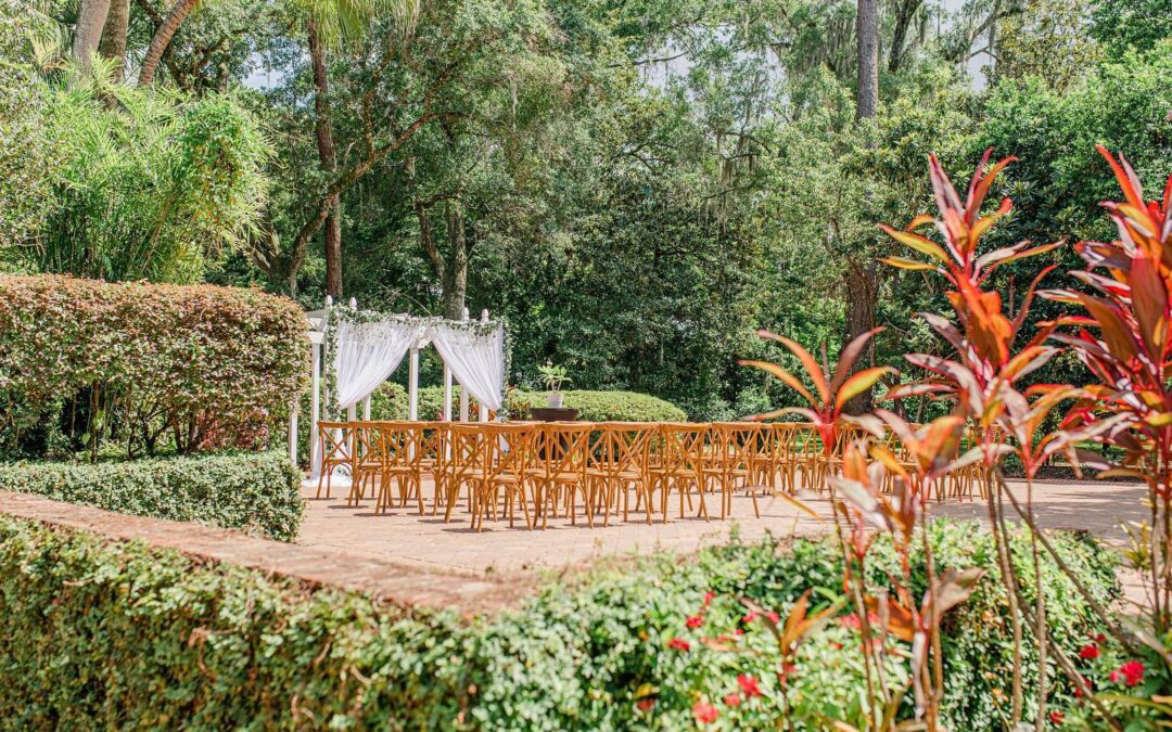 Experience the enchantment of The Garden Villa at All Inclusive Weddings Orlando. A picturesque view of the outdoor garden ceremony setup with beautifully arranged chairs and an elegant altar awaits you