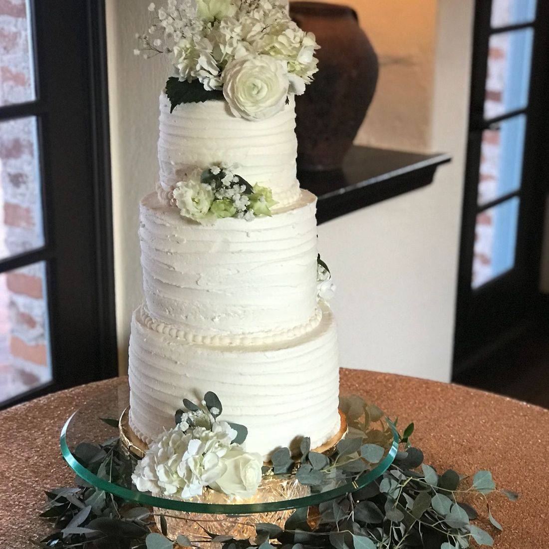 Elegant Three-Tier Traditional Wedding Cake with Floral Topper