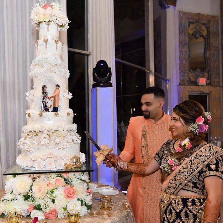 Bride and Groom Cutting Traditional Indian Wedding Cake