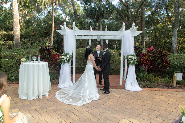 Ray officiating a beautiful couple in the serene garden of All Inclusive Weddings Orlando's Garden Villa.