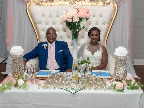 Bride and groom elegantly posing in a luxurious chair for a photo before their dinner at All Inclusive Weddings Orlando