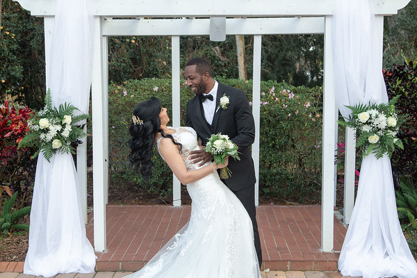 Groom dipping his bride in a romantic pose, captured at All Inclusive Weddings Orlando: A joyful moment of love and happiness between the newlyweds