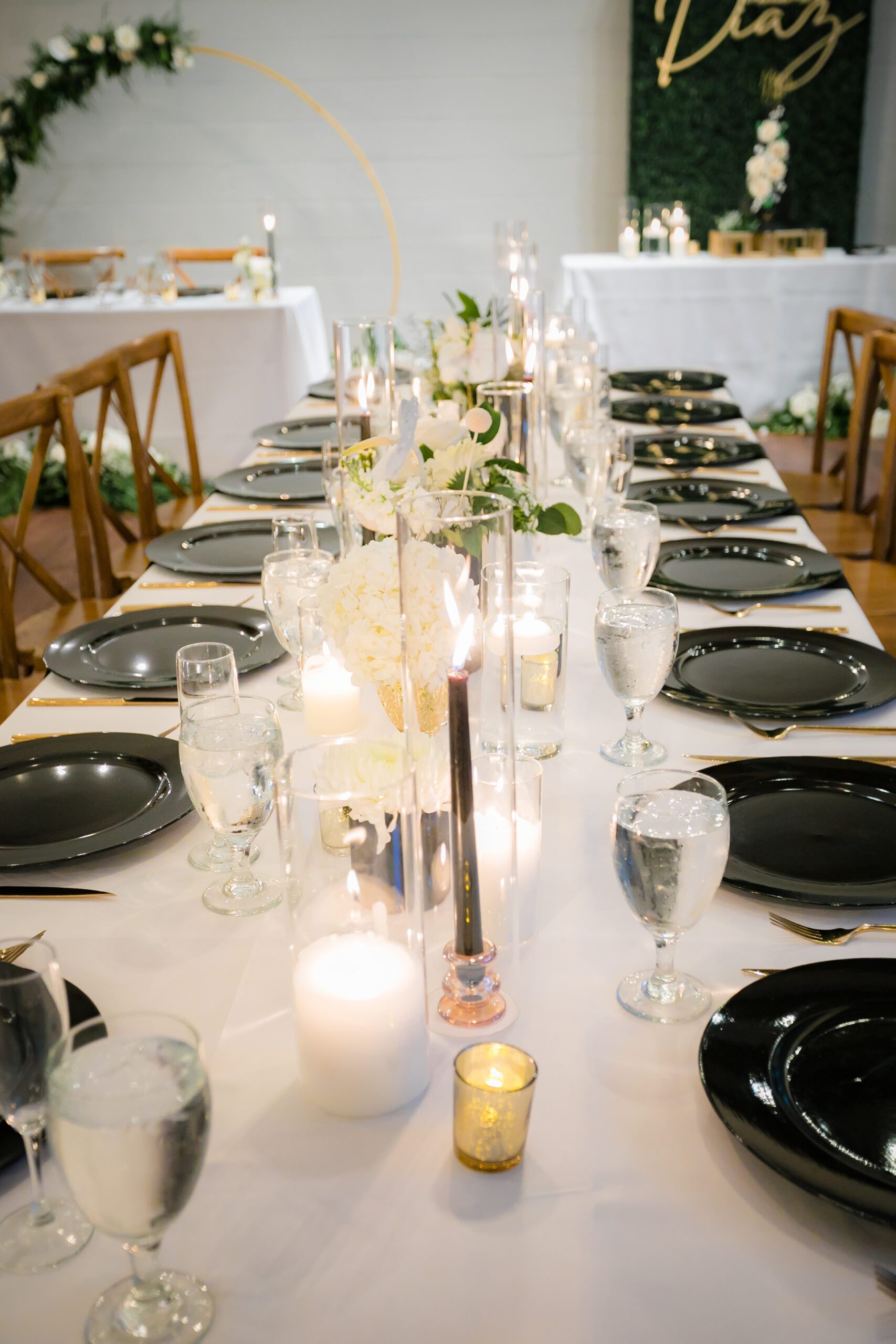 Table setting at All Inclusive Weddings Orlando: Black plates with crystal glasses of water and elegant table décor