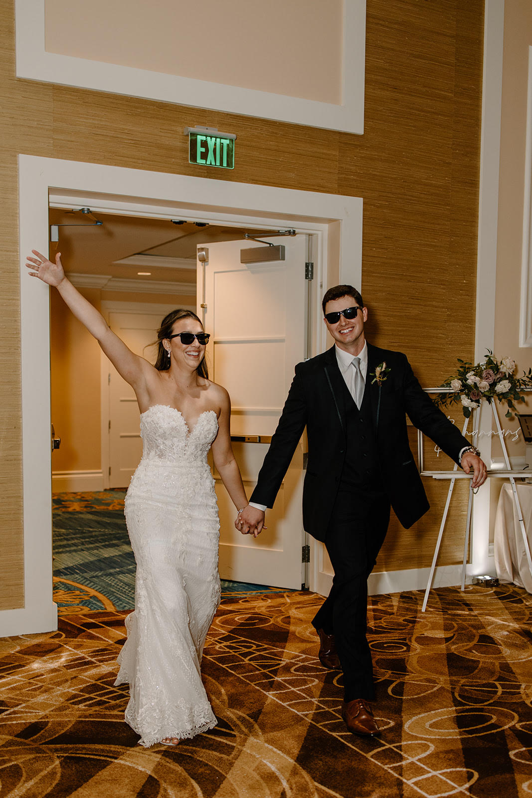 Bride and groom entering the room with cool vibes, wearing stylish sunglasses - Simply Enchanted